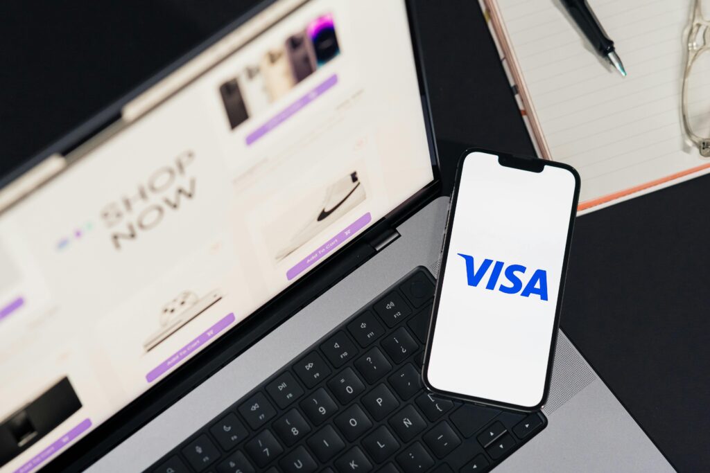 pexels photo 29502365 29502365 Smartphone displaying VISA on a laptop for online shopping experience.